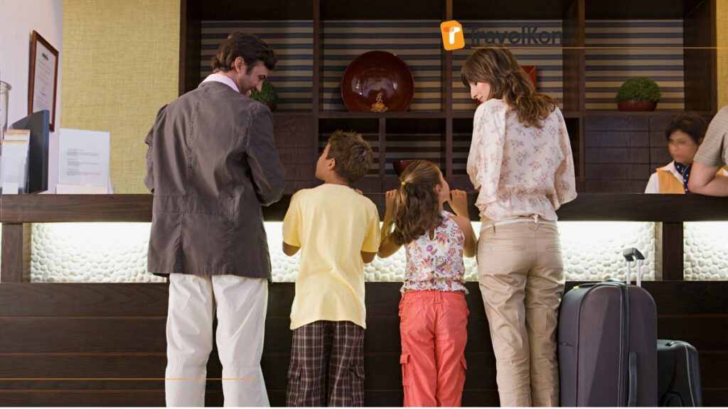 a group of people looking at a display for check in family hotel in tokyo japan