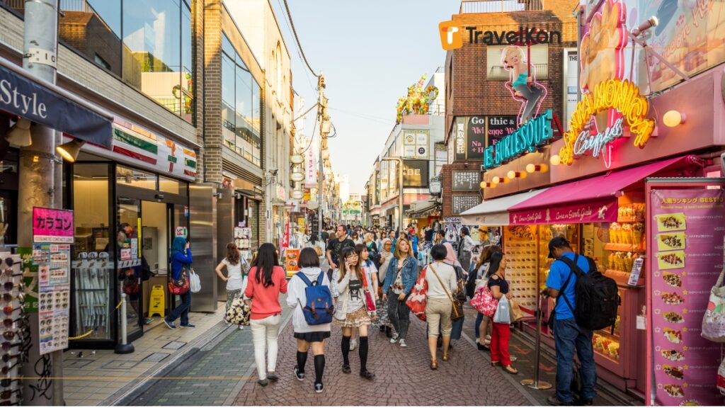 a group of people walking down takeshita  street tokyo