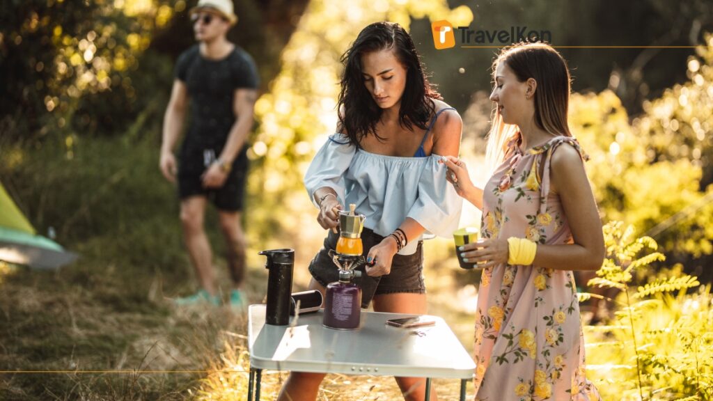 a woman standing next to a table with a coffee maker