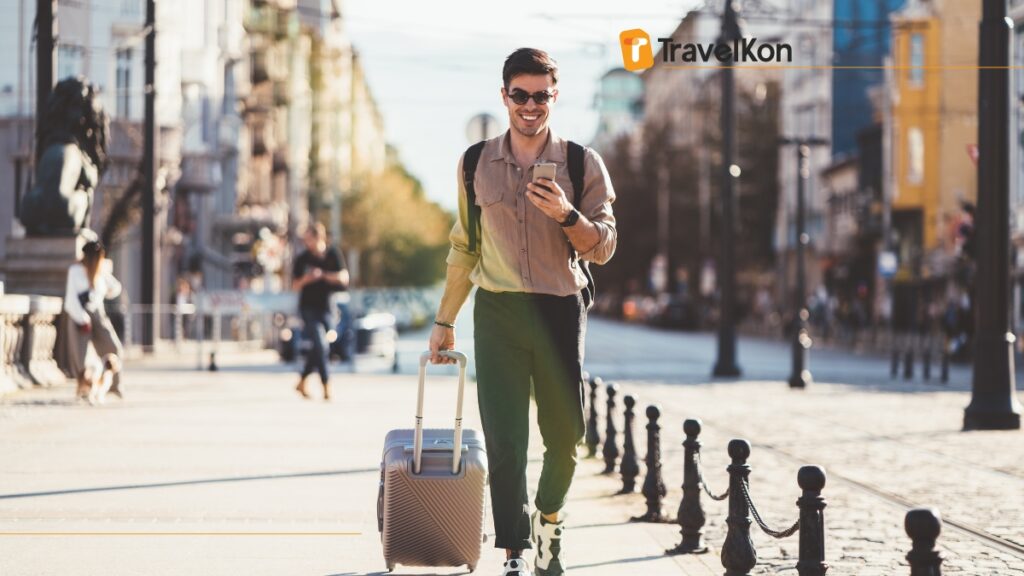 a man walking with a suitcase and phone as solo traveller